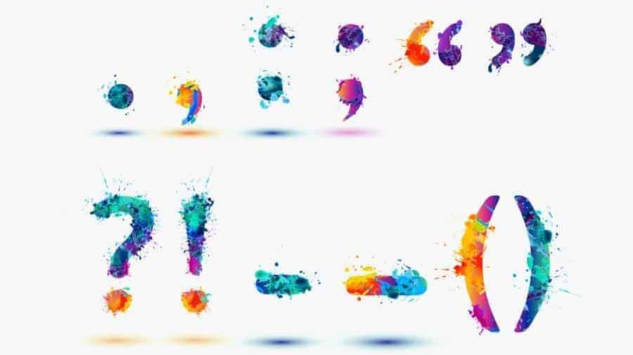 Various punctuation marks decorated with multicolored splatter paint. 